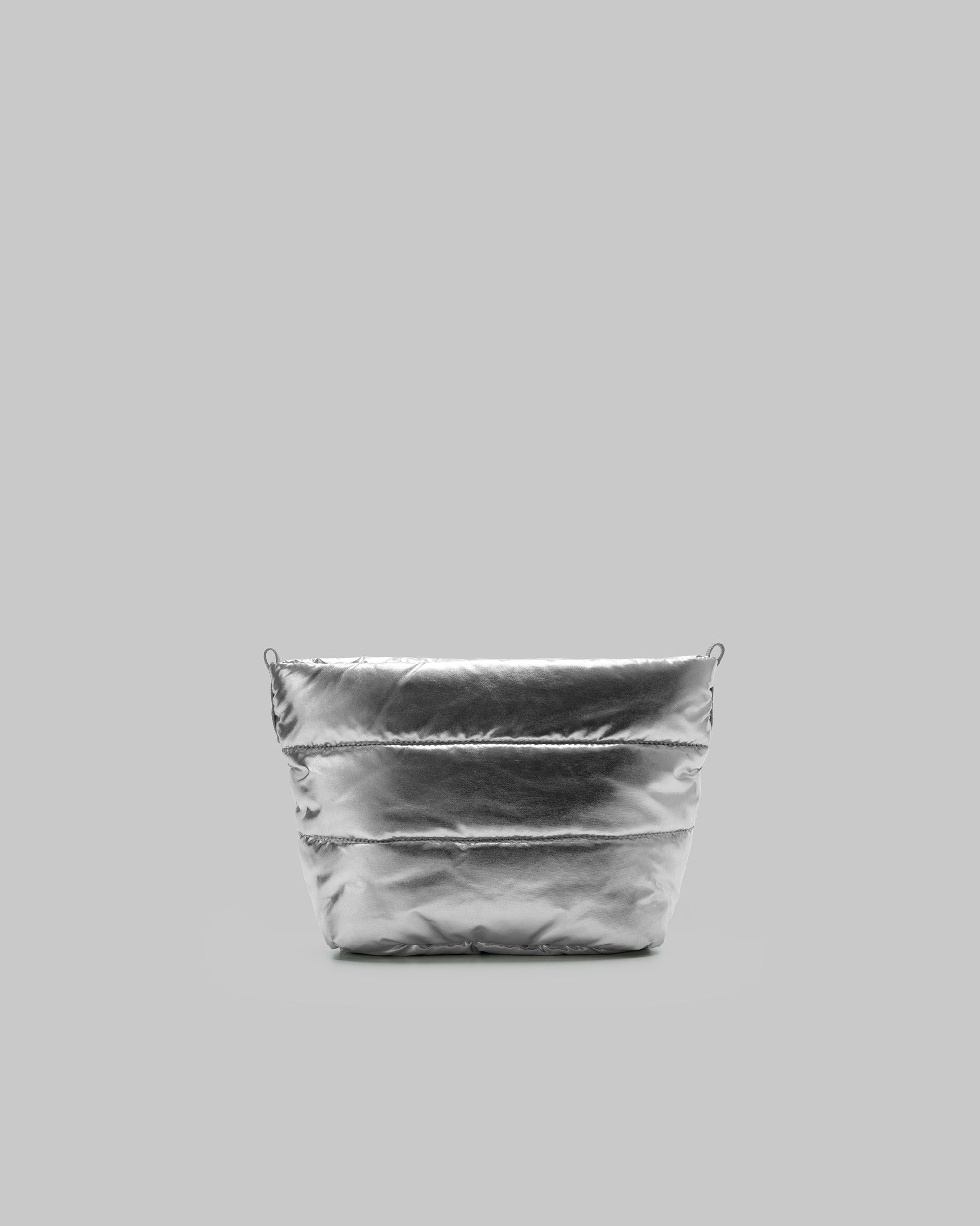 Puffy Sacoche in metallic silver quilted fabric with grey attachment loops, shown against a light grey background.