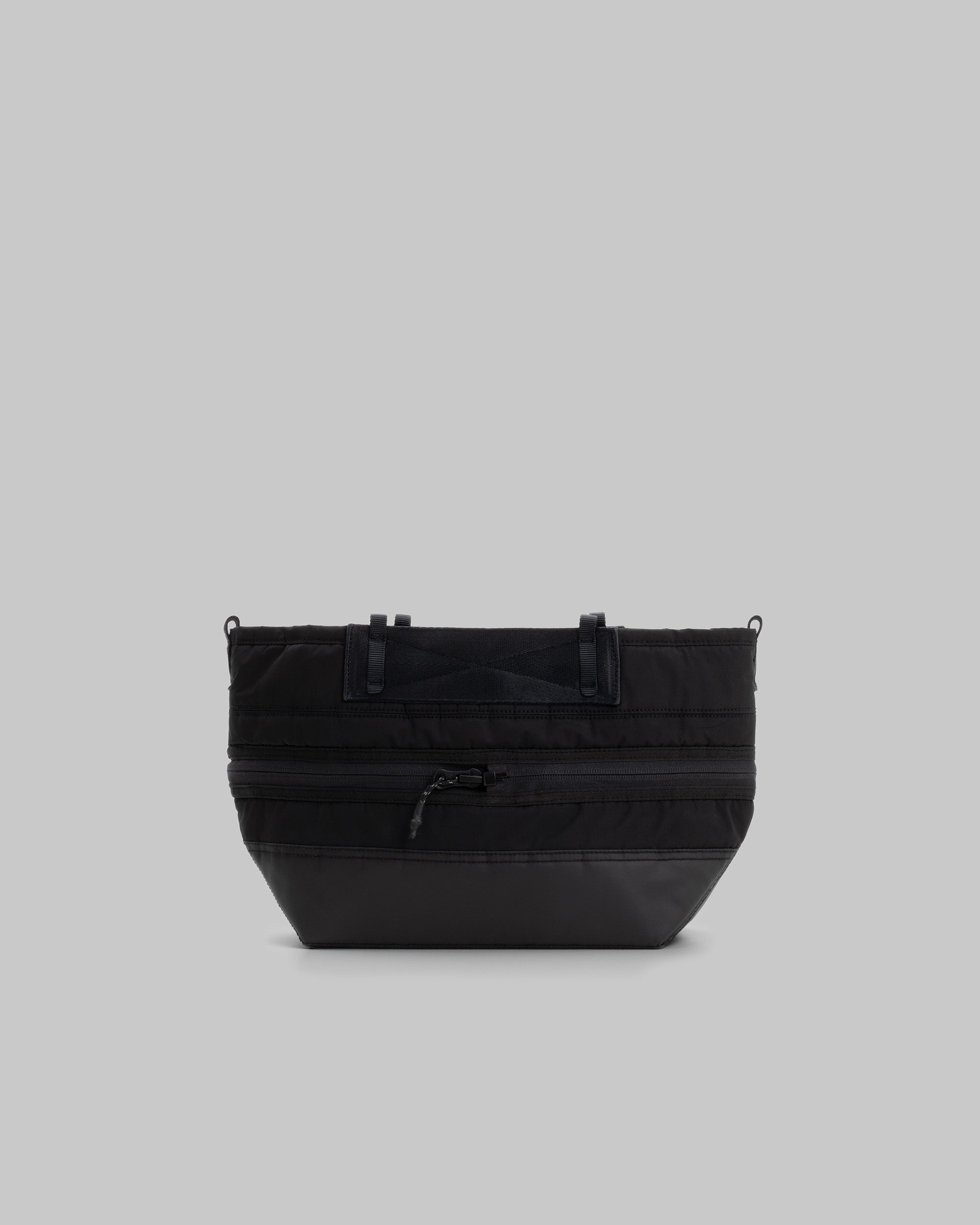 Convert Tool Bag in black puffer fabric with a matte base and black hardware, shown against a light grey background.