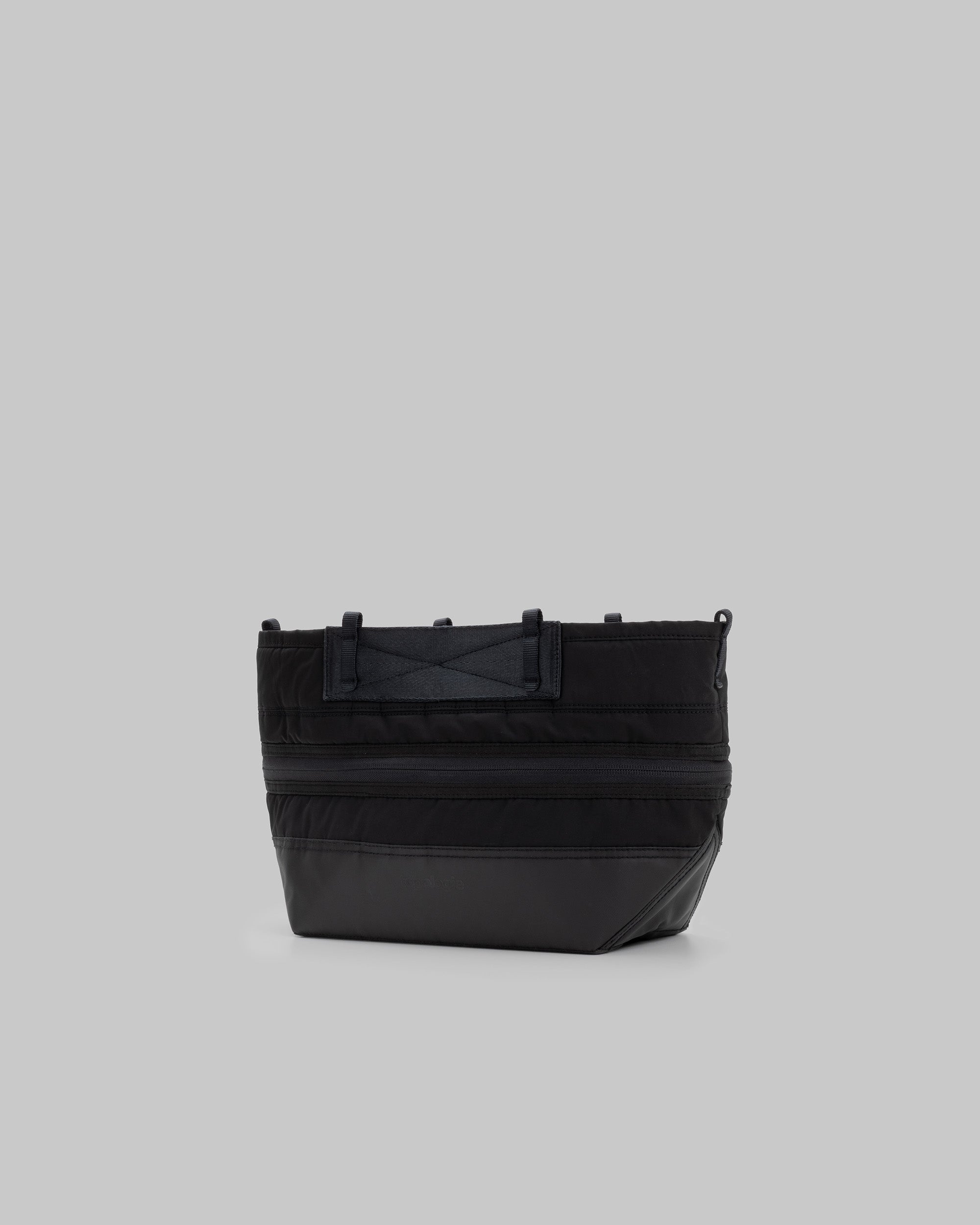 Convert Tool Bag in black with a quilted upper, matte base, and top attachment loops, shown against a light grey background.