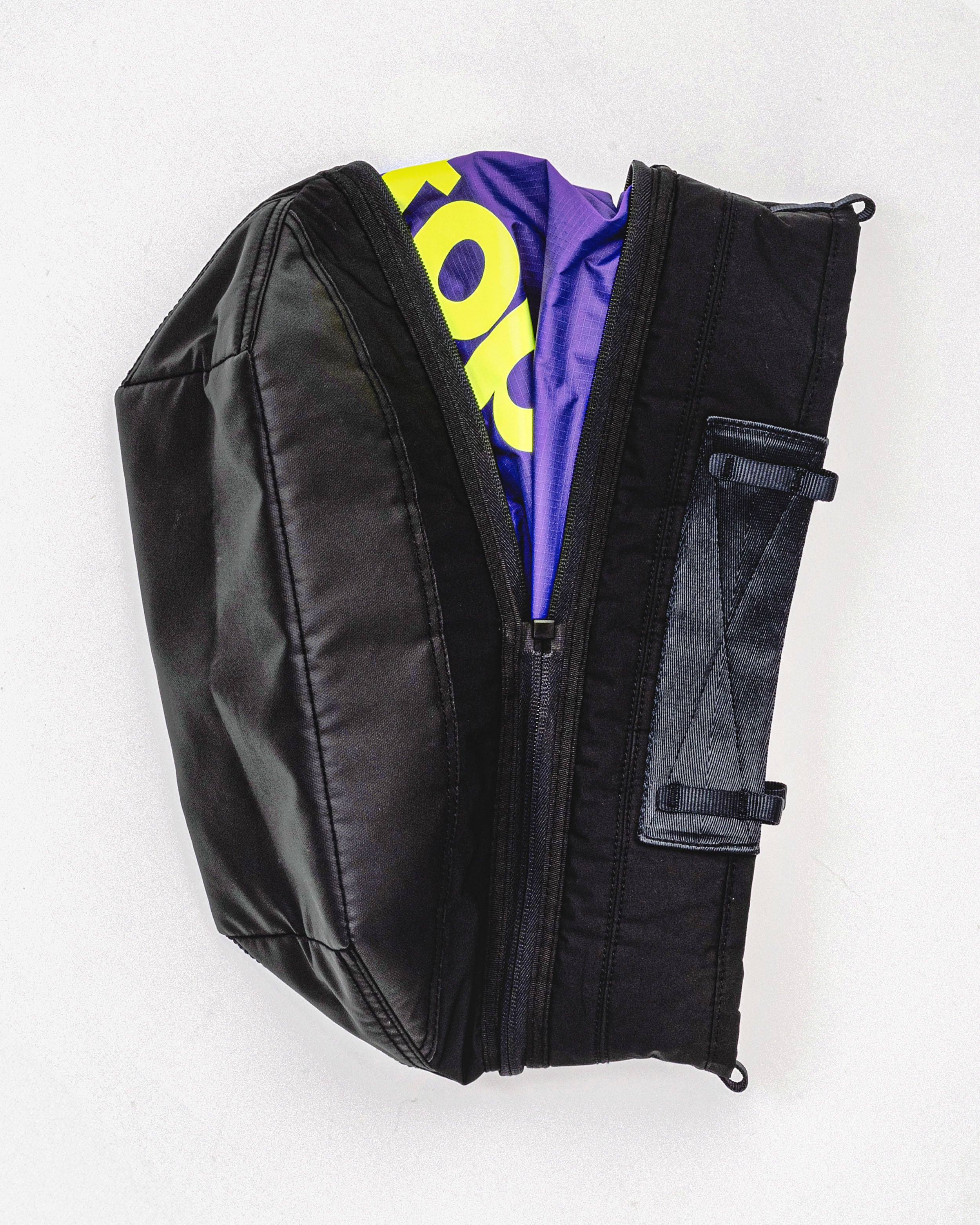 Convert Tool Bag in black, shown partially open to reveal a purple interior with a yellow topologie logo against a light grey background.