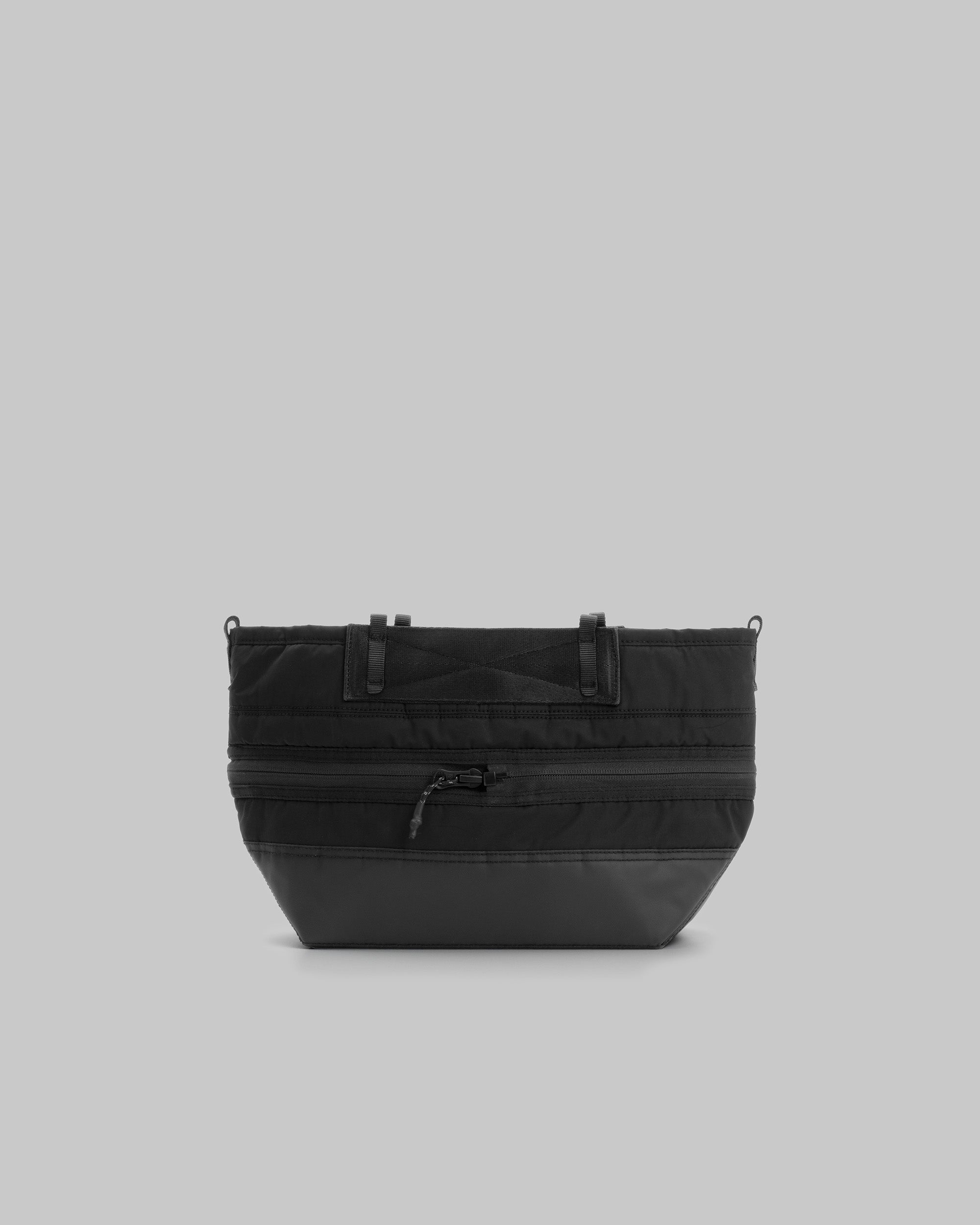 Convert Tool Bag in black padded fabric with a reinforced base, front zip, and attachment loops, shown against a light grey background.