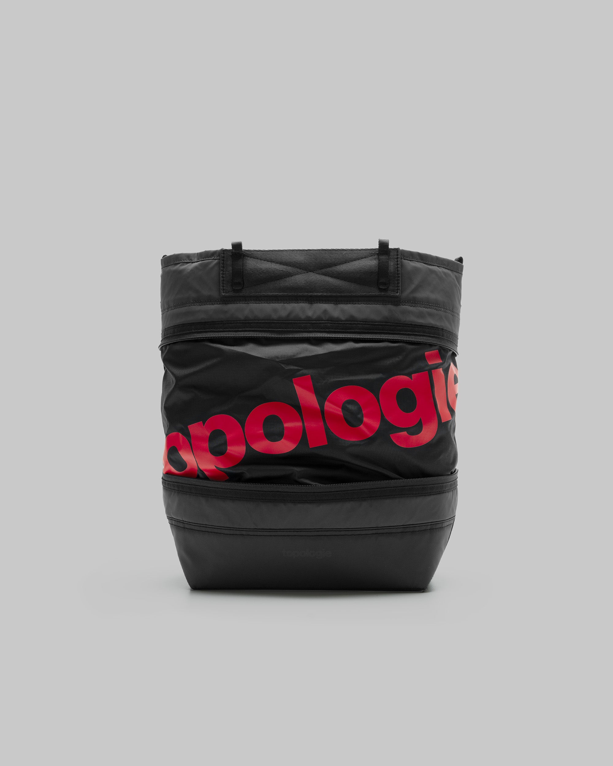 Convert Tool Bag in black with two horizontal zippers and a bold red topologie logo, shown against a light grey background.