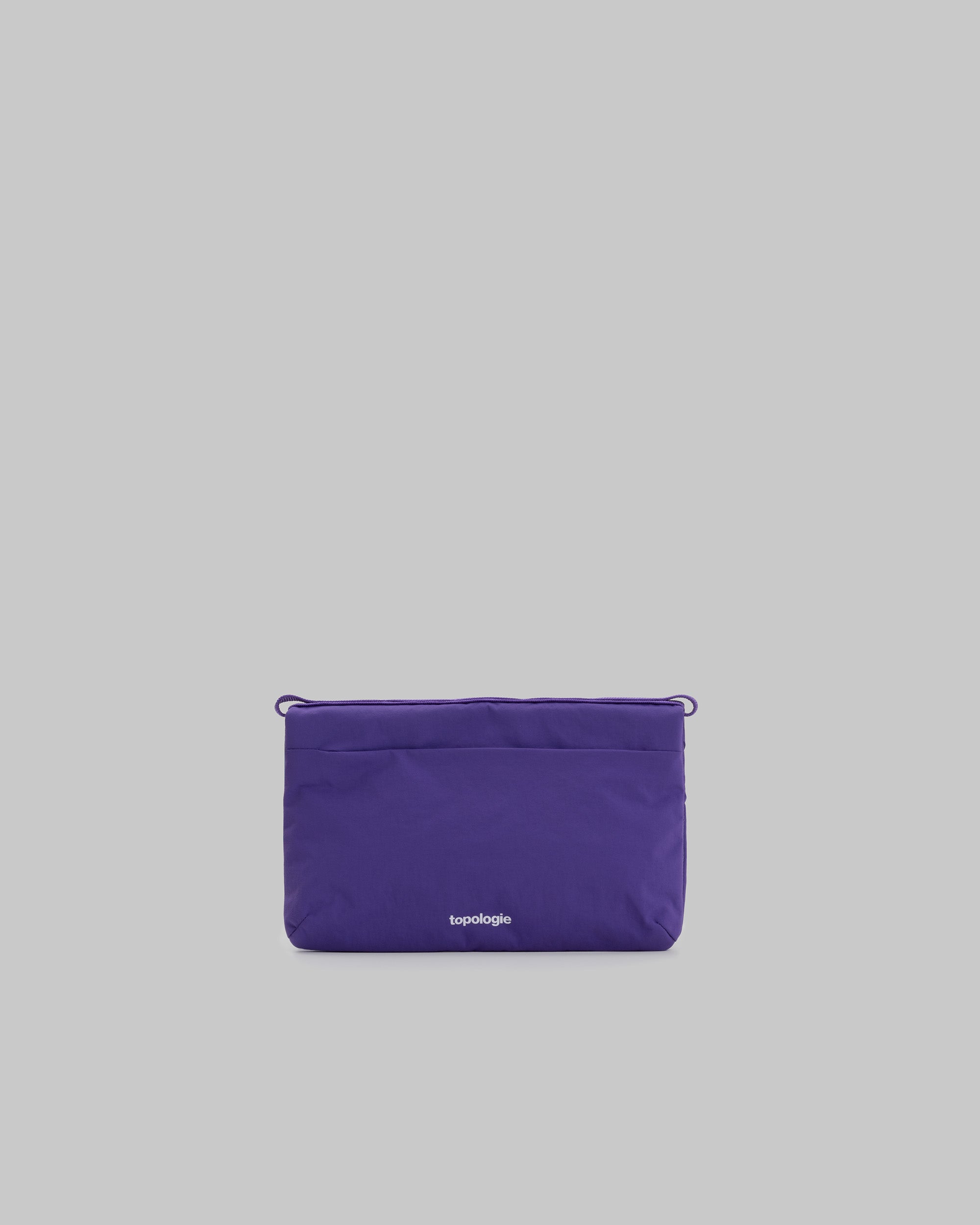 Flat Sacoche Small in purple nylon with a white topologie logo and cord loops at the top corners, shown against a light grey background.