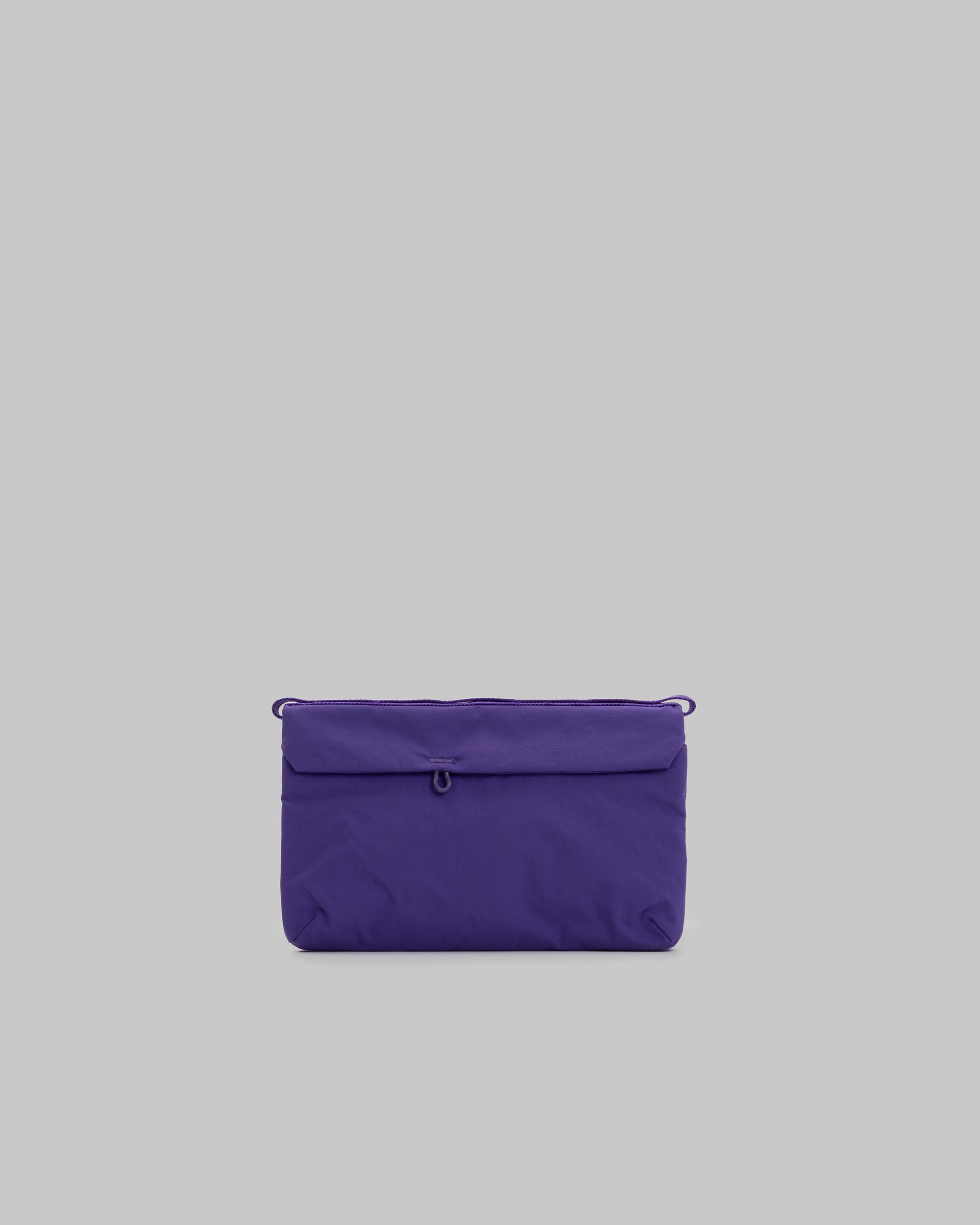 Flat Sacoche Small in purple with a front flap loop and side attachment loops, shown against a light grey background.