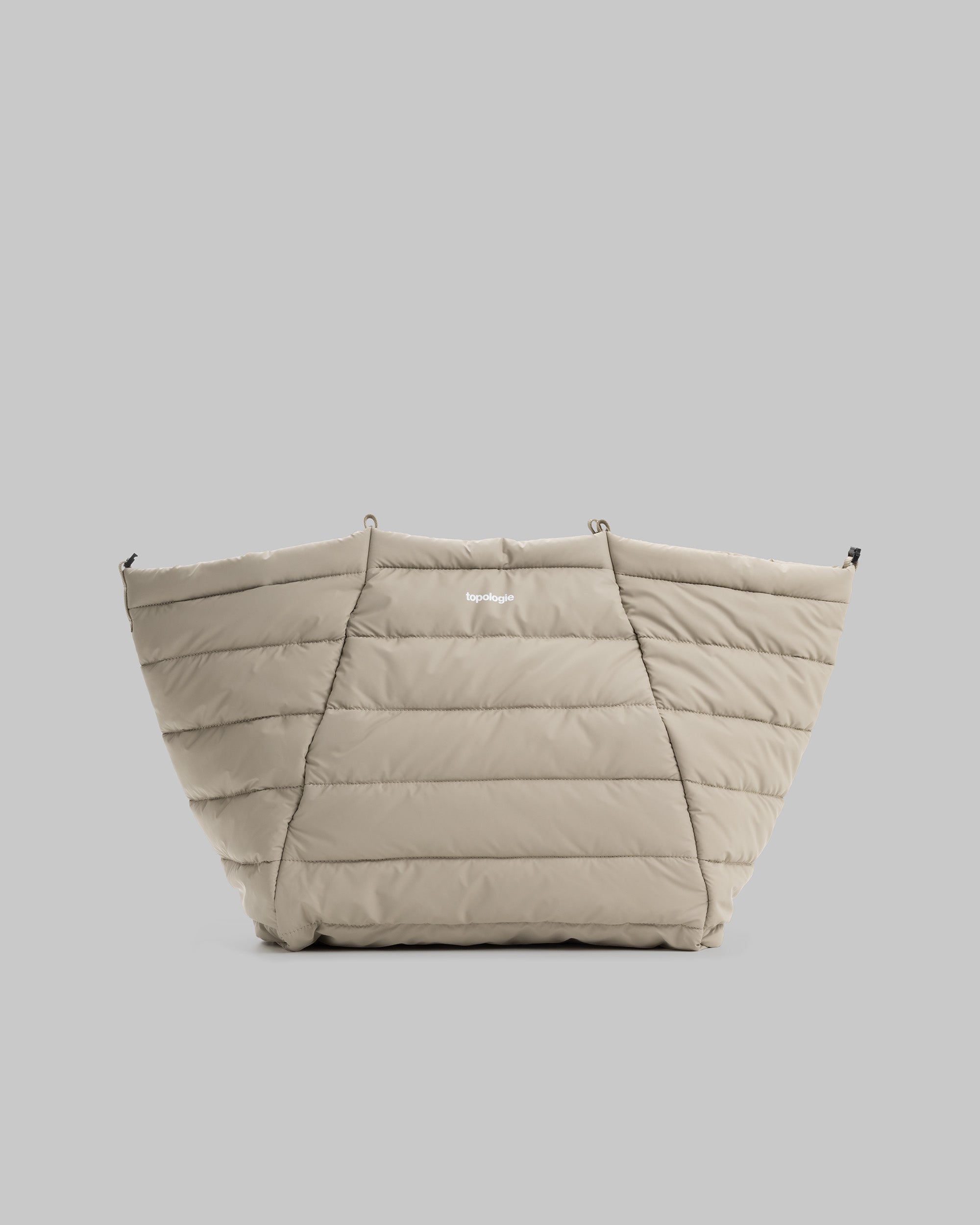 Marche Tote Large in taupe quilted nylon with horizontal stitching and a small white topologie logo, shown against a light grey background.