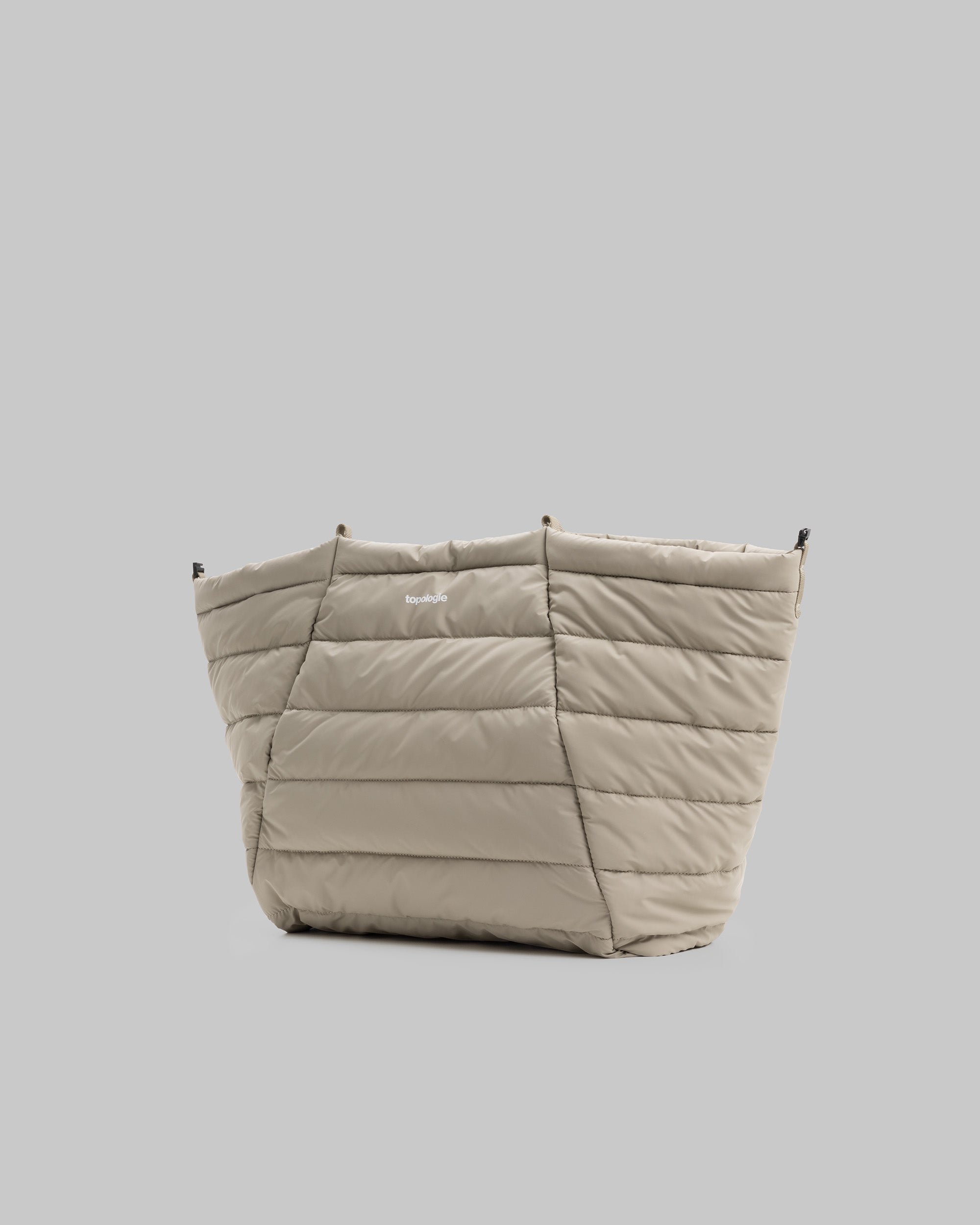 Marche Tote Large in taupe quilted fabric with a white topologie logo, shown against a light grey background.