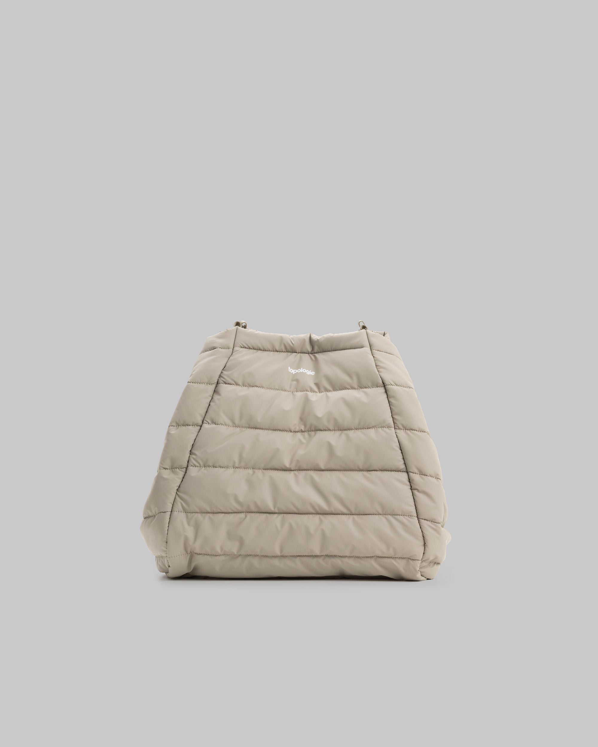 Marche Tote Large in light beige with horizontal quilted stitching and a small white topologie logo near the top edge.