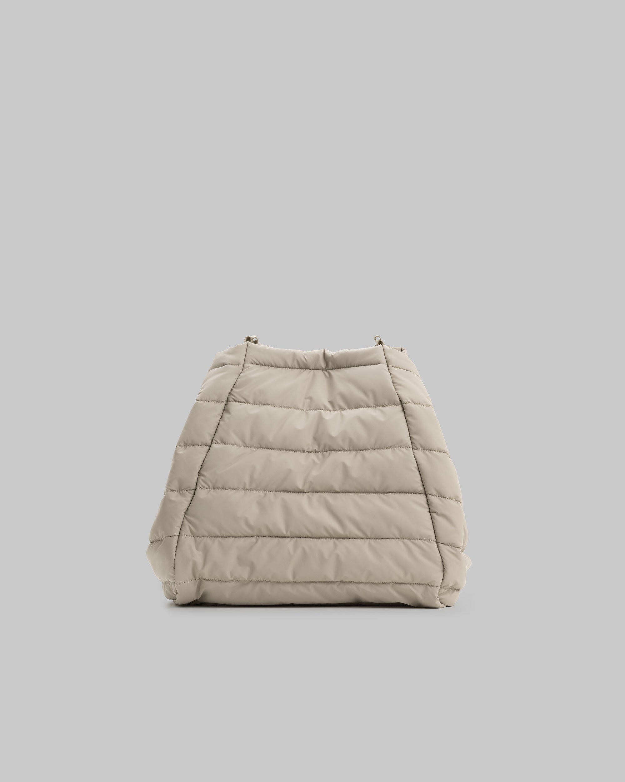 Marche Tote Large in taupe quilted needle ripstop with horizontal padding and small metal loops, shown against a light grey background.