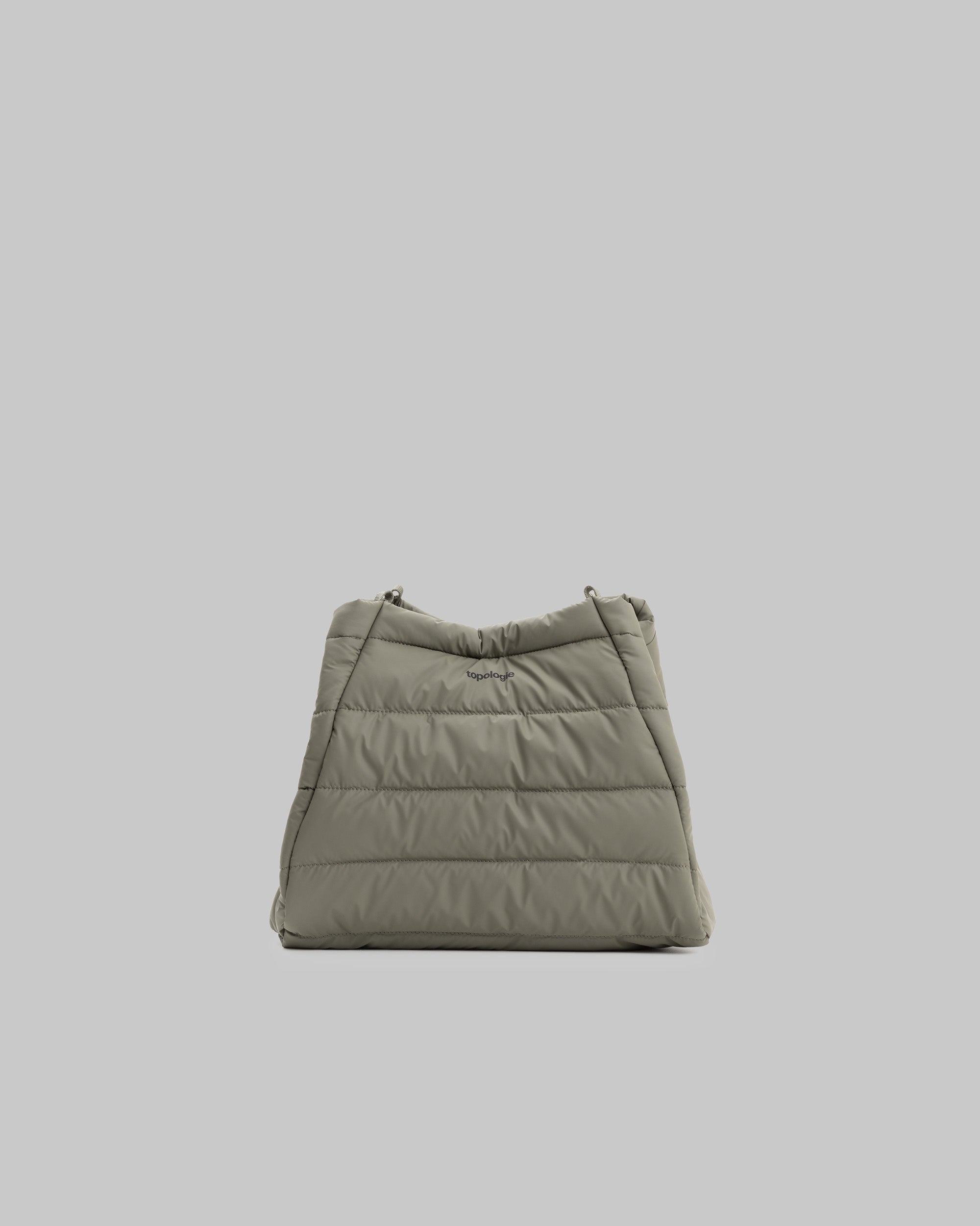 Marche Tote Medium in moss quilted needle ripstop with horizontal padding and a small black topologie logo, shown against a light grey background.