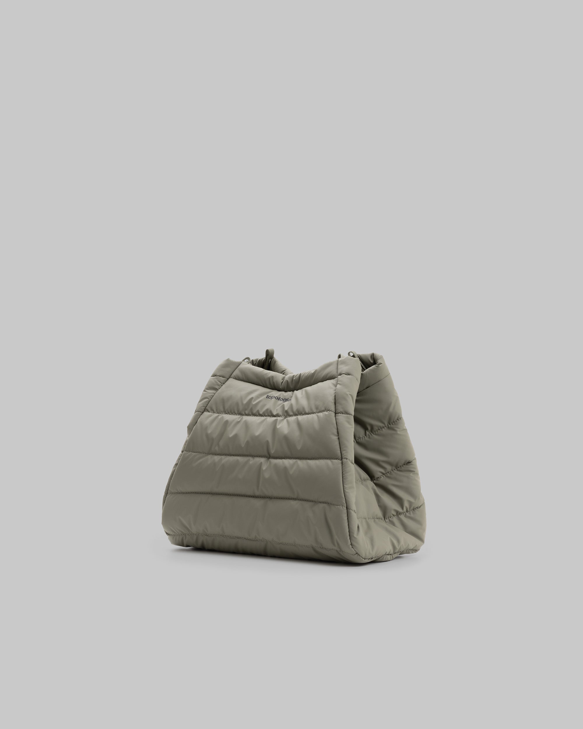 Marche Tote Medium in moss green quilted fabric with a black topologie logo, shown against a light grey background.
