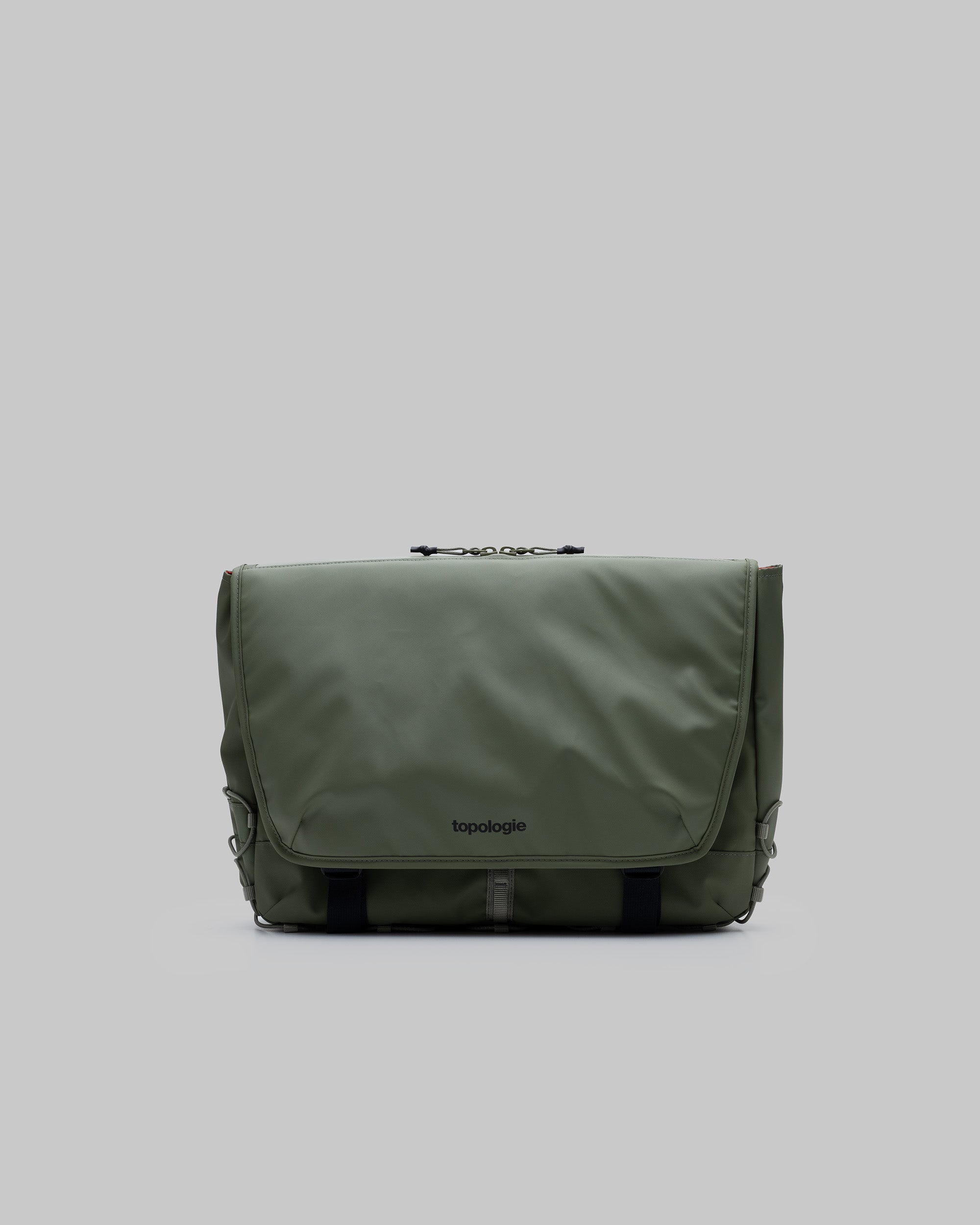Messenger Sacoche Large in moss green with a black topologie logo and black webbing straps, shown against a light grey background.