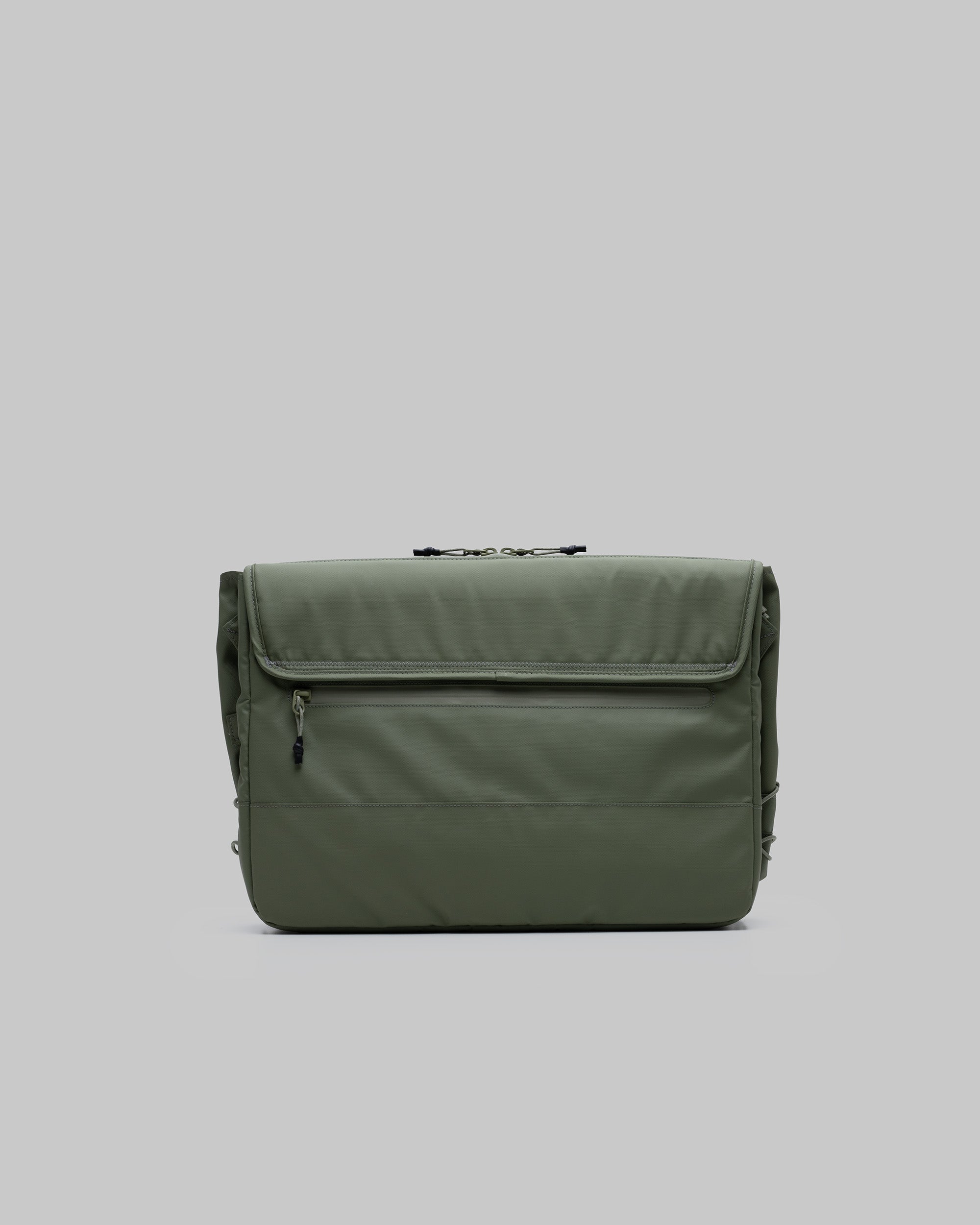 Messenger Sacoche Large in moss green needle ripstop with a front zippered pocket and top flap closure, shown against a light grey background.