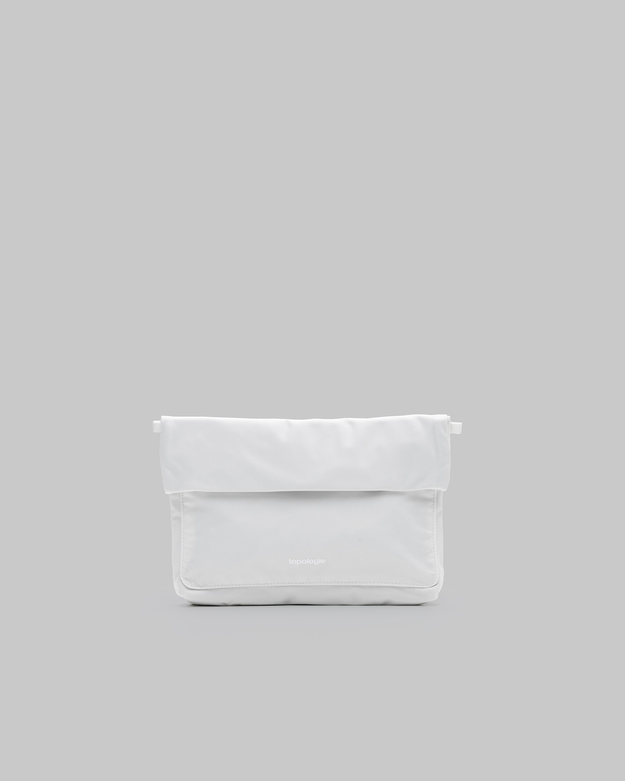 Musette Medium in marshmallow white with a front compartment and central snap, shown against a light grey background.