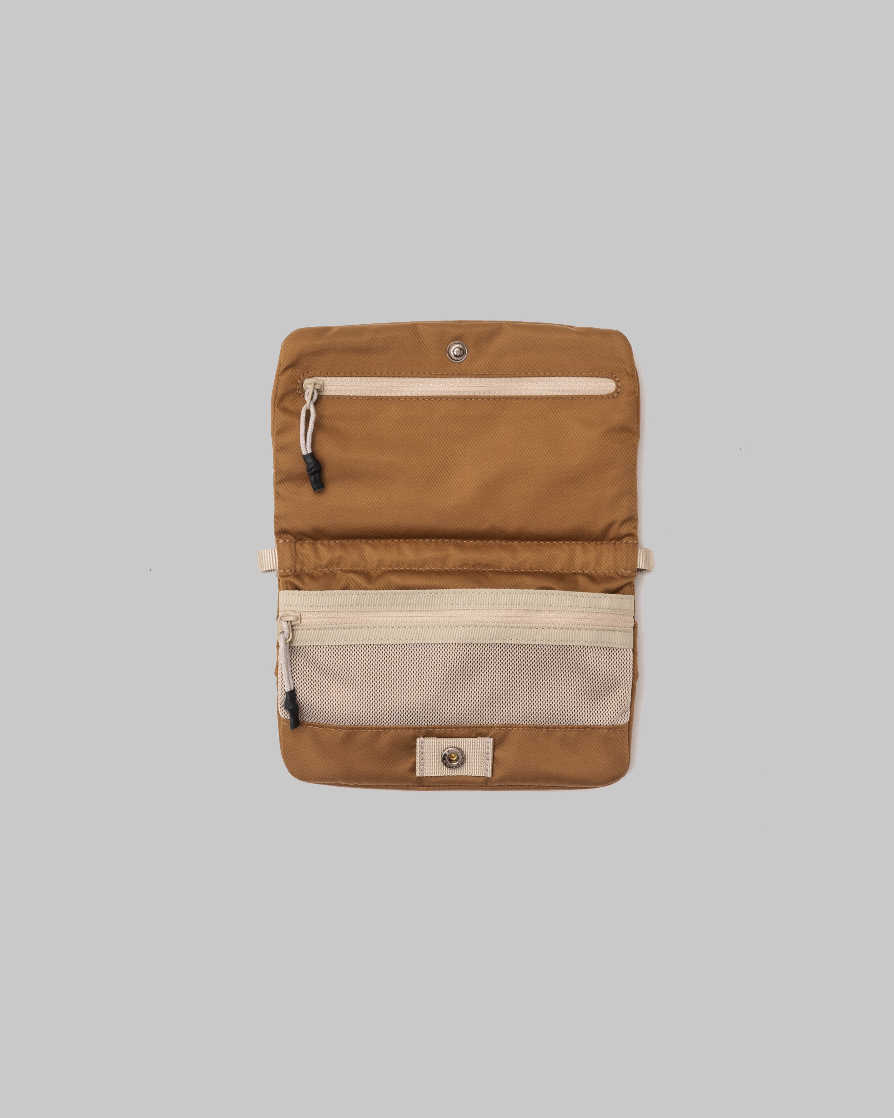 Phone Sacoche 90 in copper shown open with zippered pockets and a cream mesh compartment, against a light grey background.