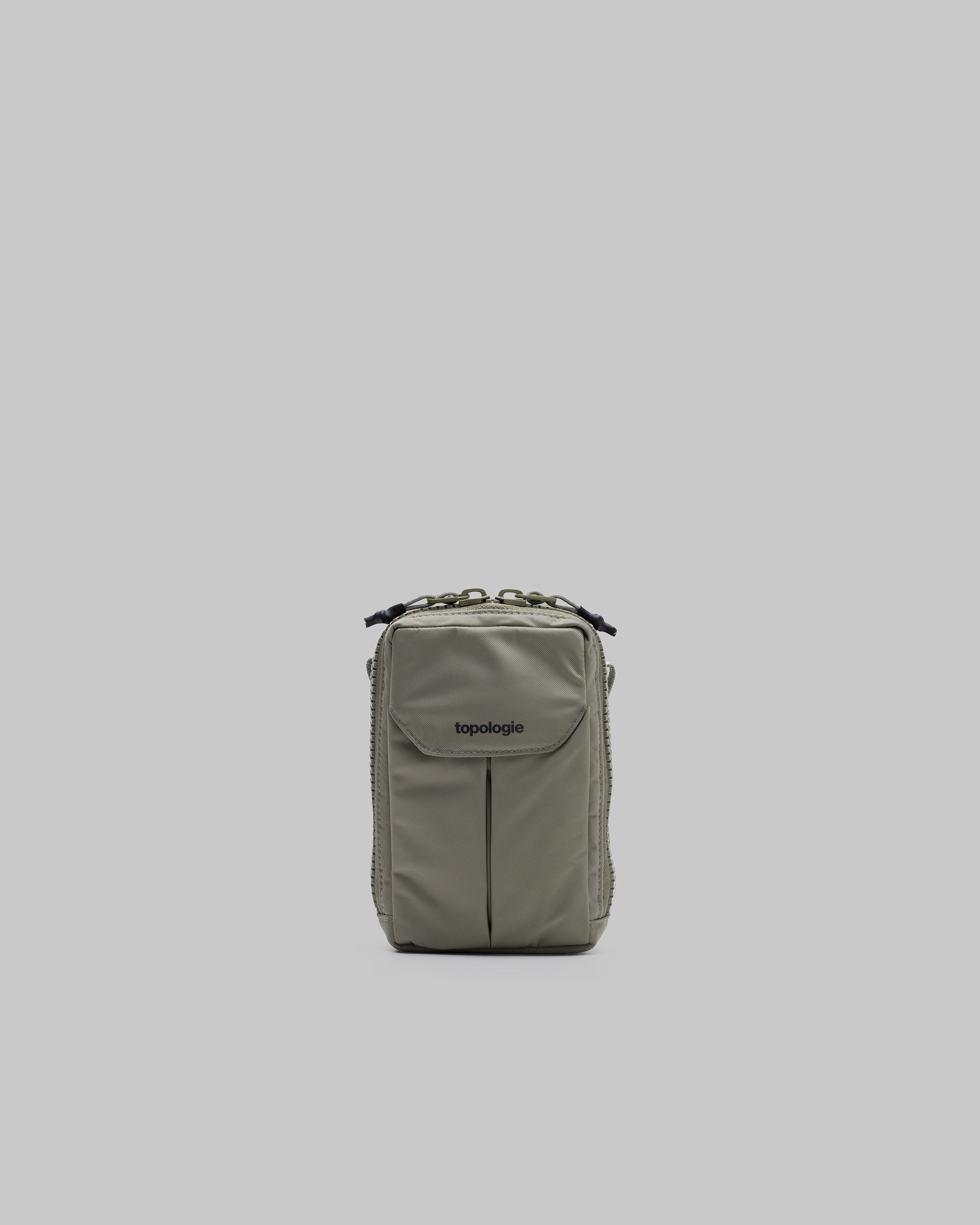 Utility Phone Sacoche in sage green nylon featuring a front flap pocket with the topologie logo, shown against a light grey background.