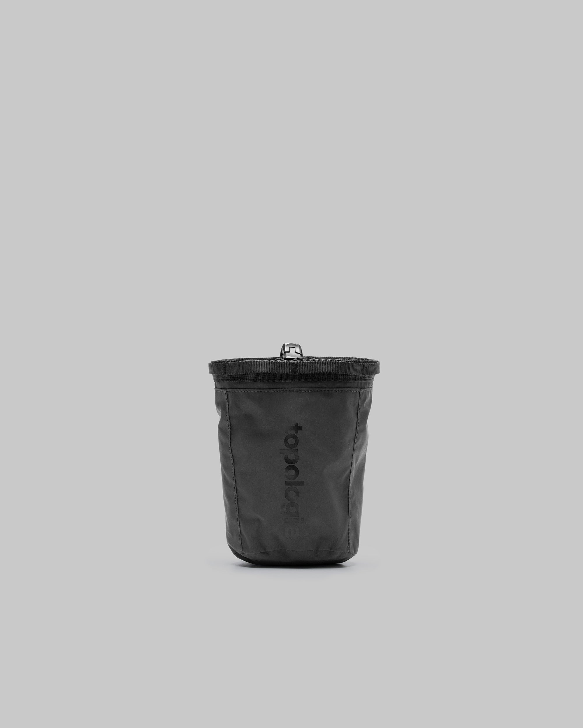 Chalk Bumbag in black with a zip pocket and adjustable webbing strap, shown against a light grey background.