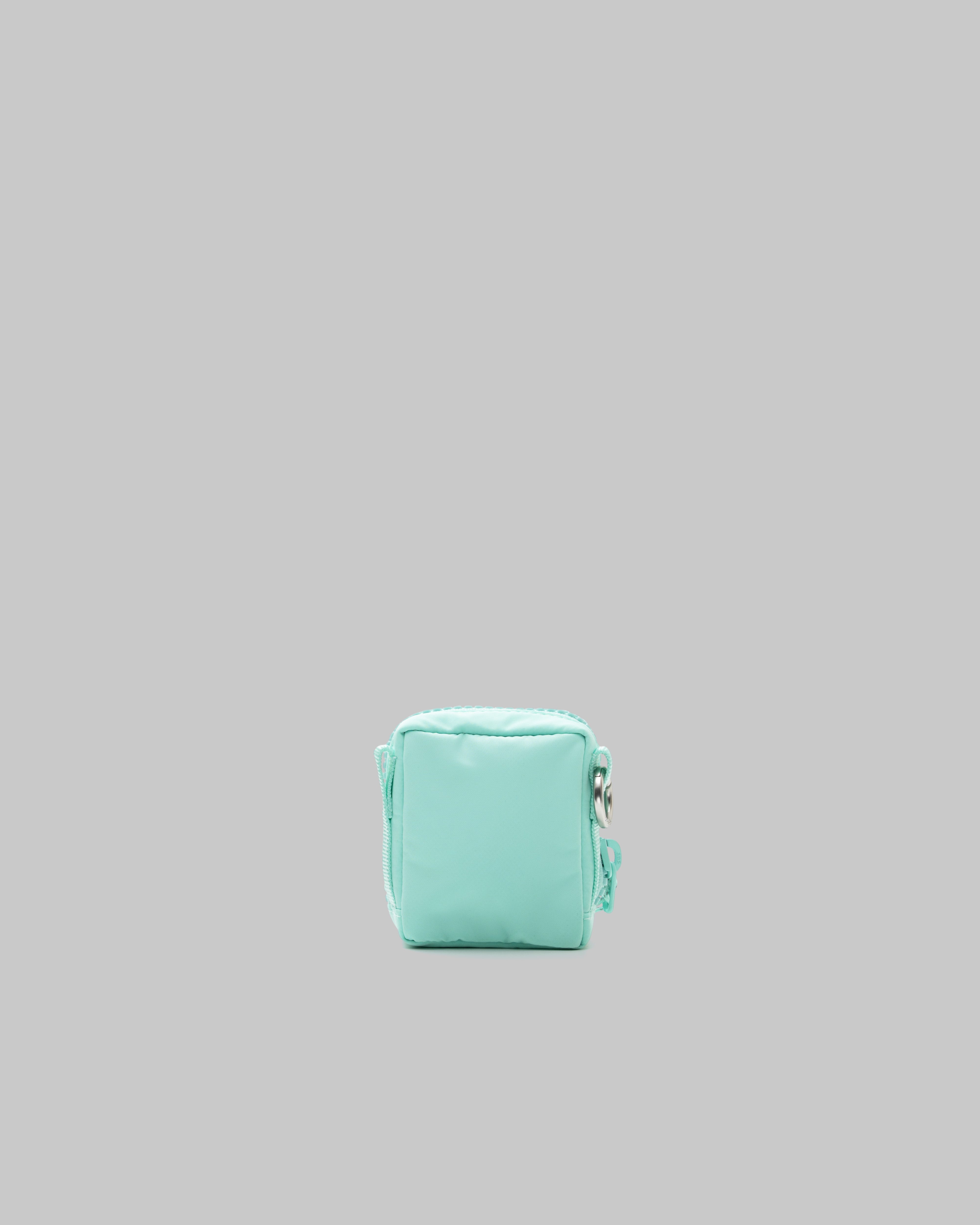 Mini Utility Sacoche in mint green puffy fabric with a matching zipper and silver metal ring, shown against a light grey background.